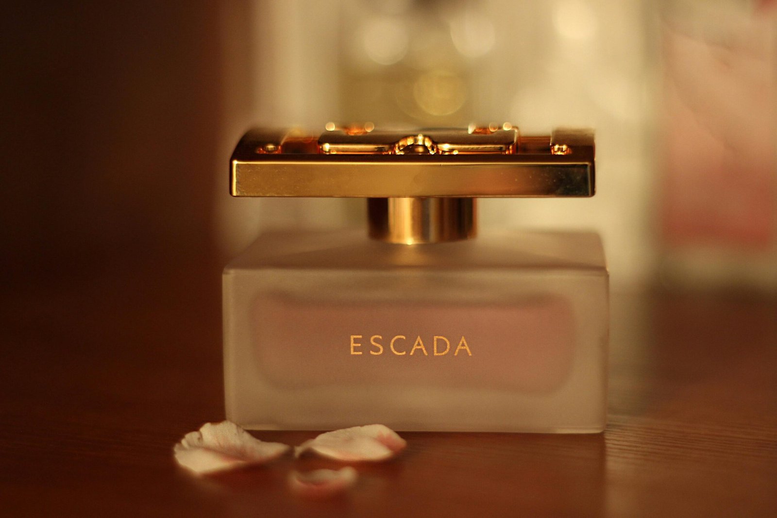 pexels-photo-724635-724635 Close-up of a luxury perfume bottle with petals on a wooden table.